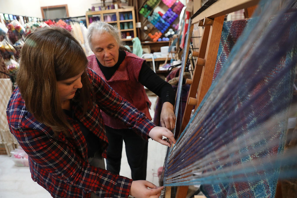 Carol Leigh Brack-Kaiser teaches her student how to weave